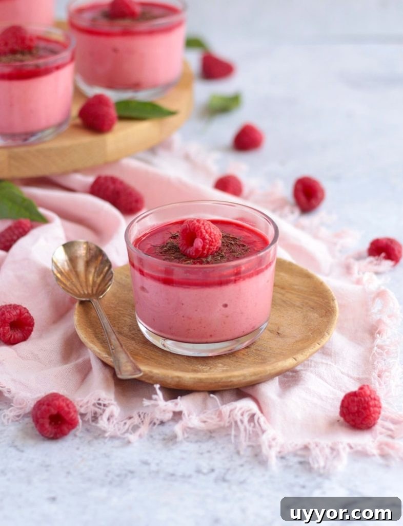 One mousse placed over a small wooden plate with a spoon.
