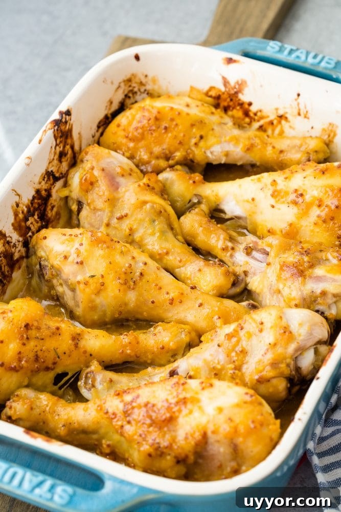 Crispy Honey Mustard Baked Chicken Drumsticks Recipe 3 chicken drumsticks with yellow sauce on them