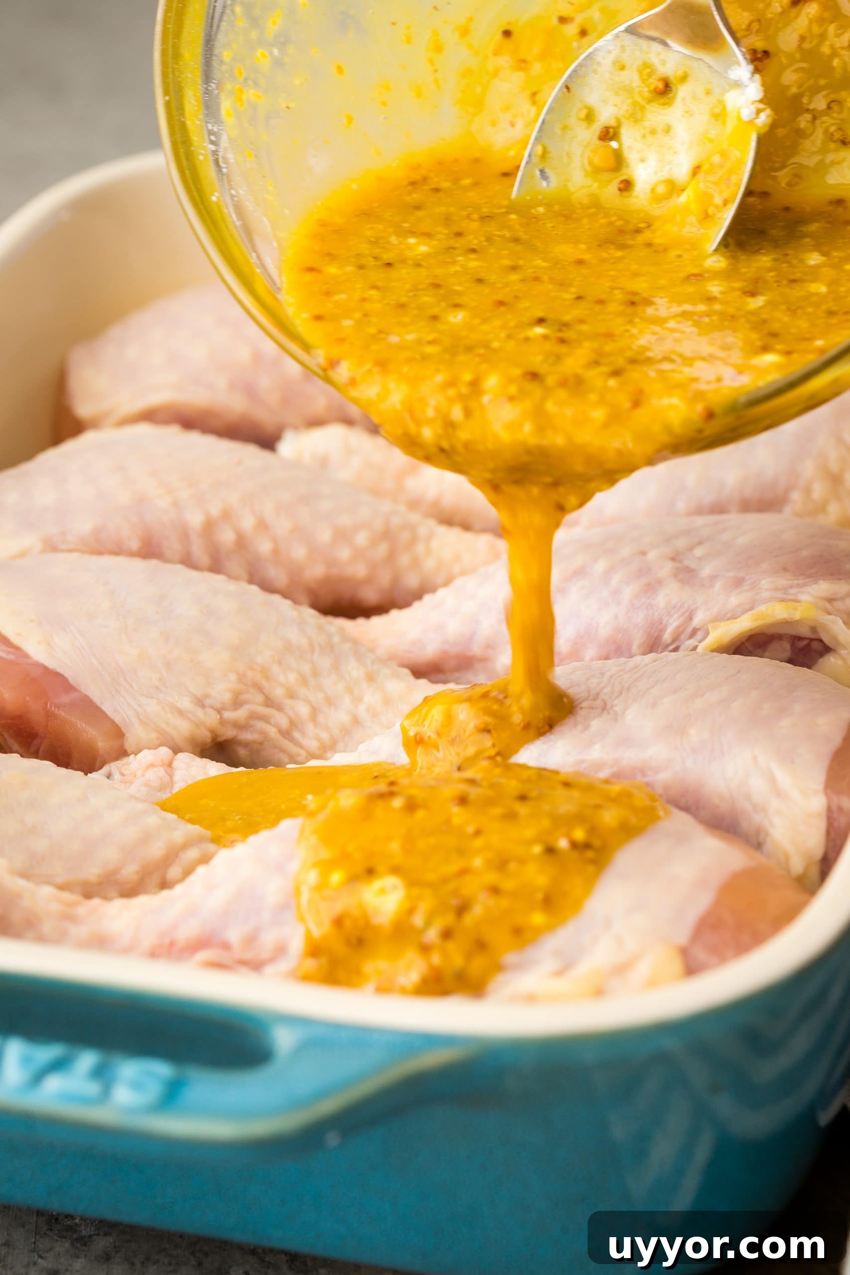 Crispy Honey Mustard Baked Chicken Drumsticks Recipe 7 Honey mustard sauce poured over chicken breasts in a baking dish.