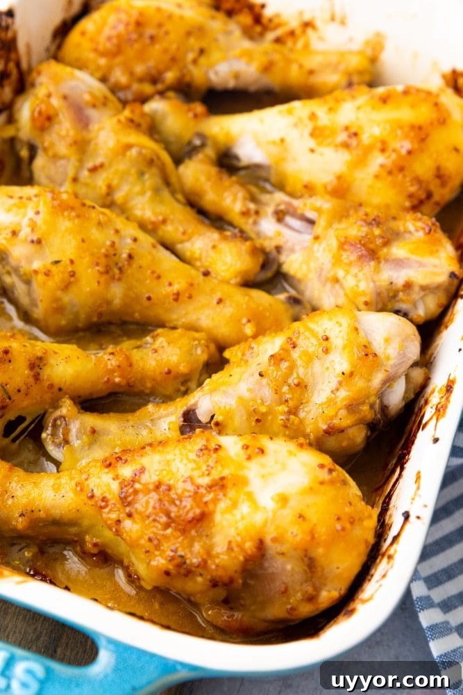 Crispy Honey Mustard Baked Chicken Drumsticks Recipe 9 chicken drumsticks with yellow sauce on them