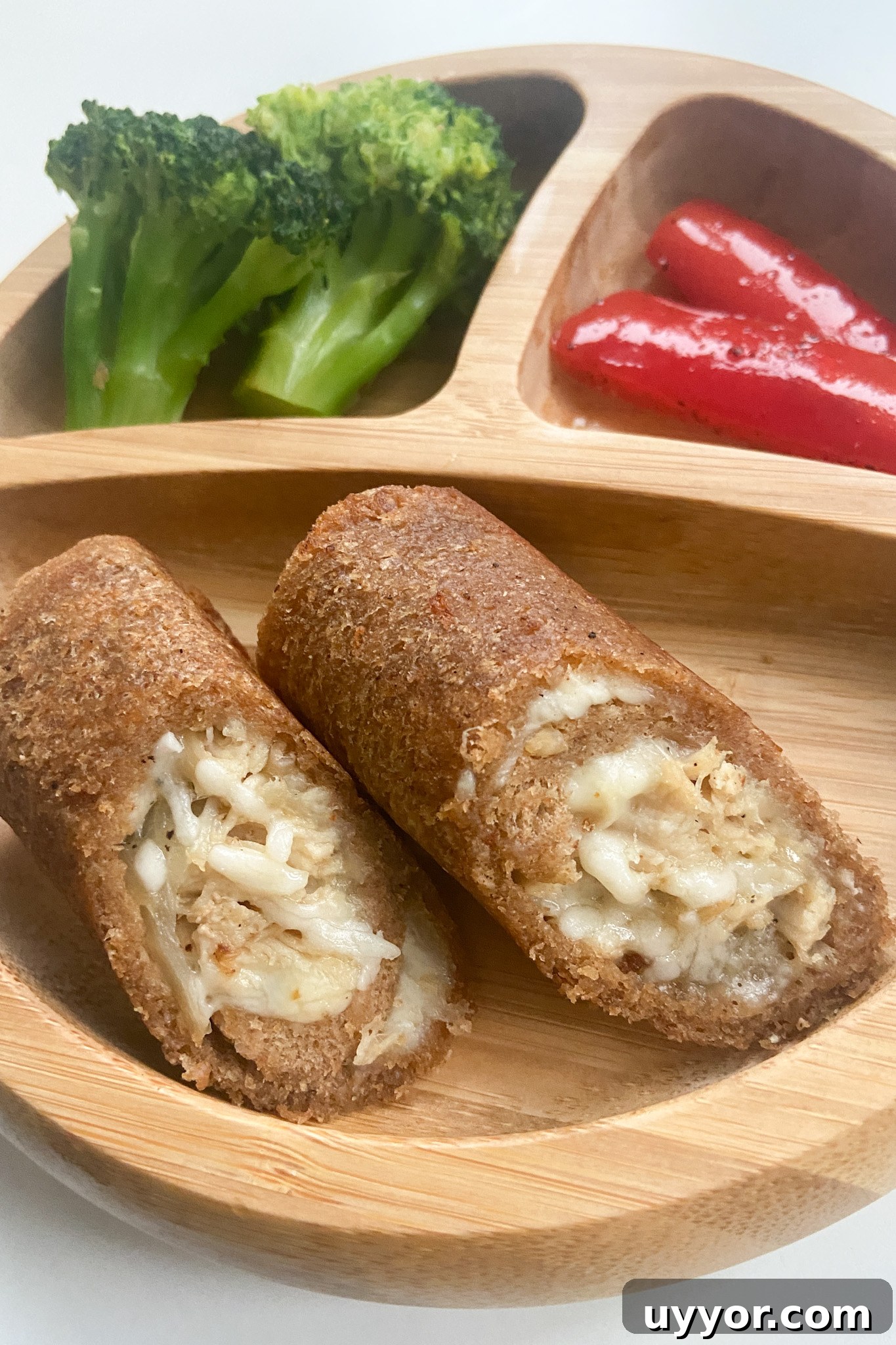 Cheesy Chicken Stuffed Bread Rolls Recipe 2 Cheesy chicken rollups served with broccoli and red bell peppers