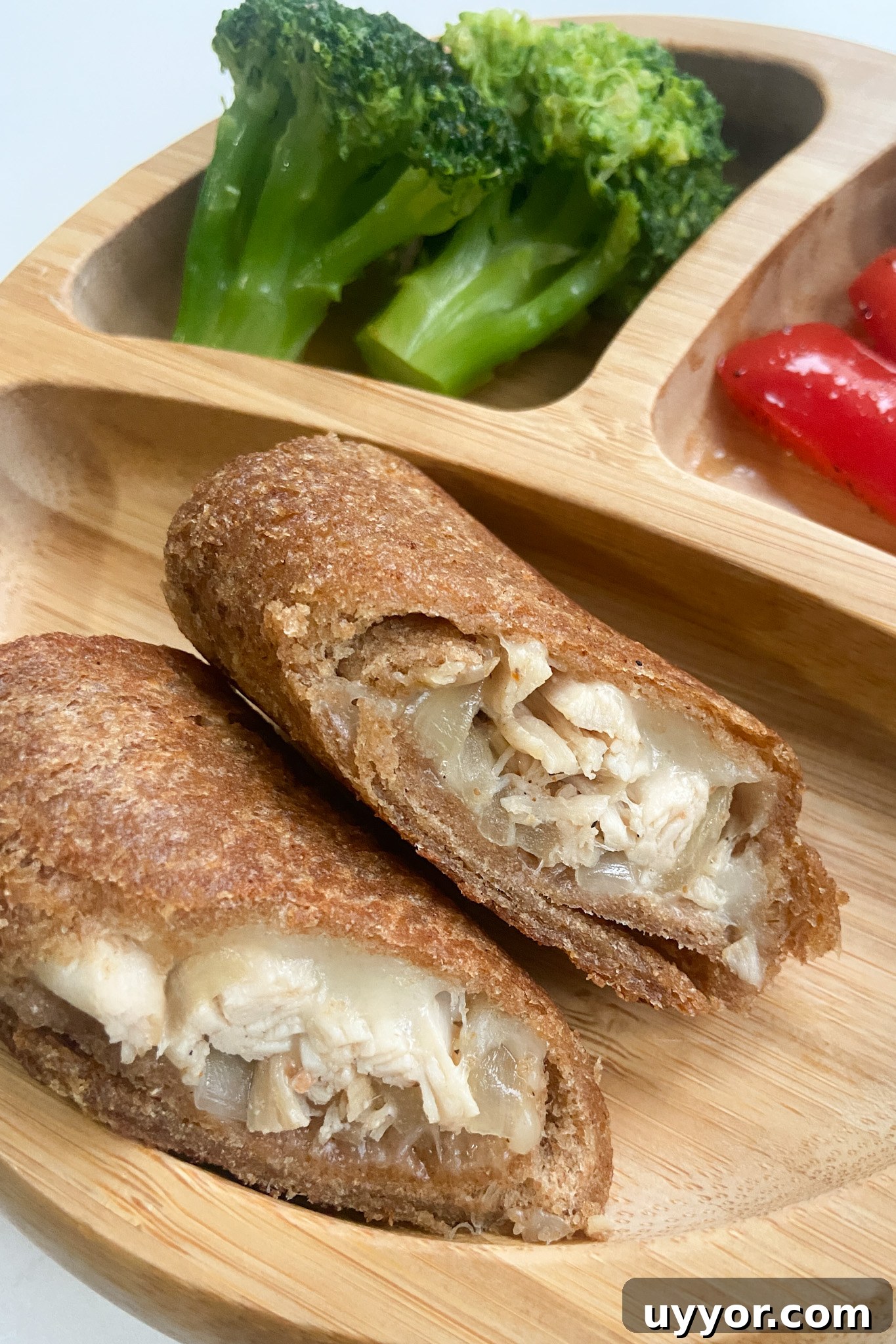 Cheesy Chicken Stuffed Bread Rolls Recipe 7 Cheesy chicken rollups served with broccoli and red bell peppers