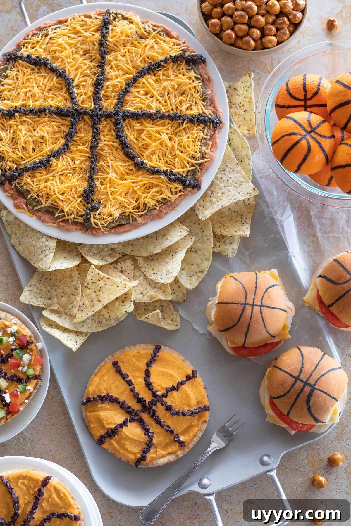50+ Winning March Madness Game Day Recipes and Snacks 2 Overhead of March Madness Food Ideas displayed around a silver party tray.