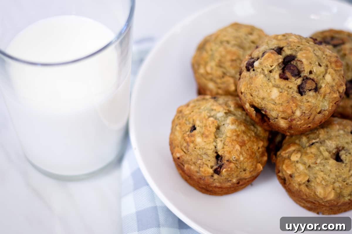 Sourdough Banana Oat Muffins with Maple Glaze 2 A plate with sourdough banana oat muffins and glass of milk.