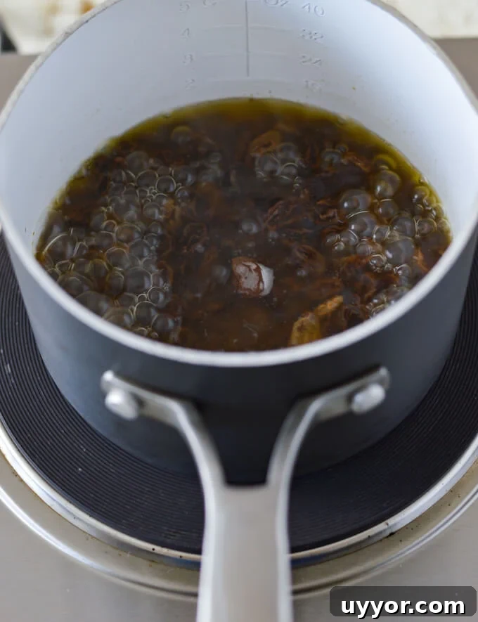 Raisin boiling in water in a pan.