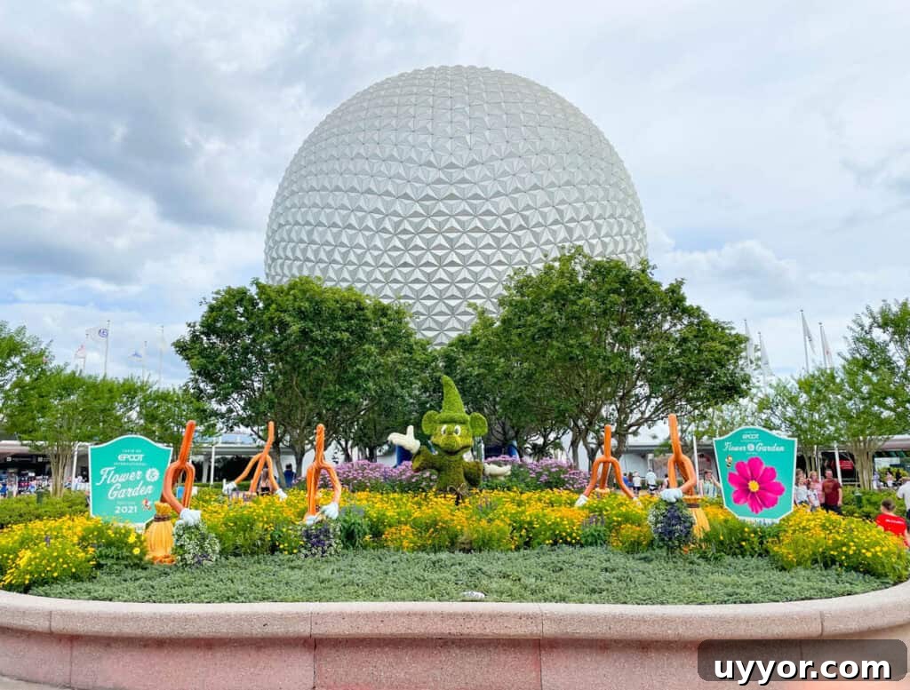 Top Tips for Navigating Epcot Festivals Like a Pro 2 Flower and Garden Festival signs in front of Spaceship Earth.