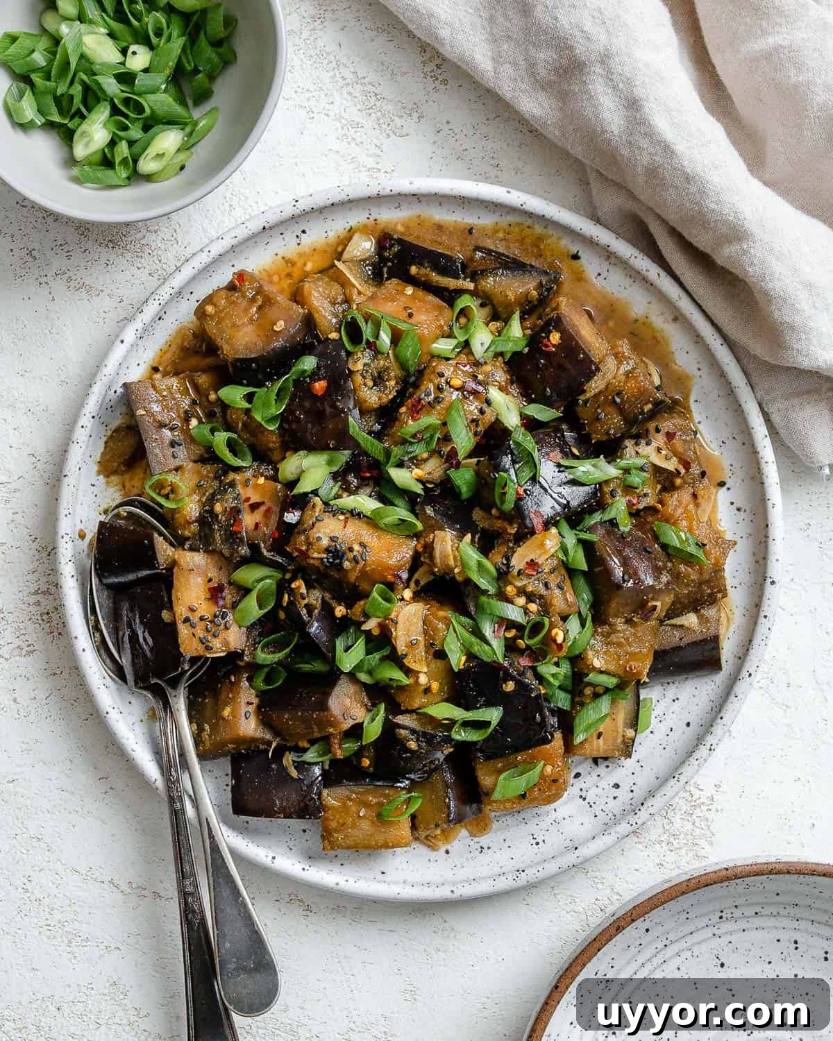 completed Perfect Sautéed Eggplant plated on a plate against a white background