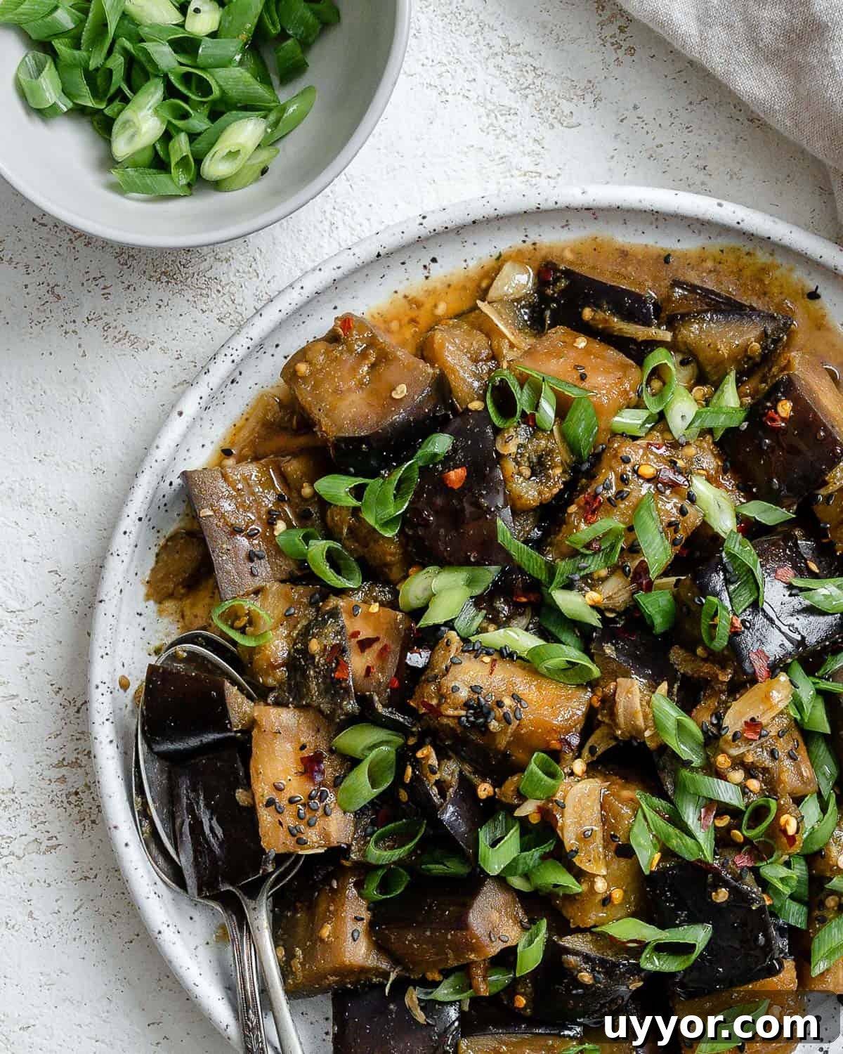 completed Perfect Sautéed Eggplant plated on a plate against a white background