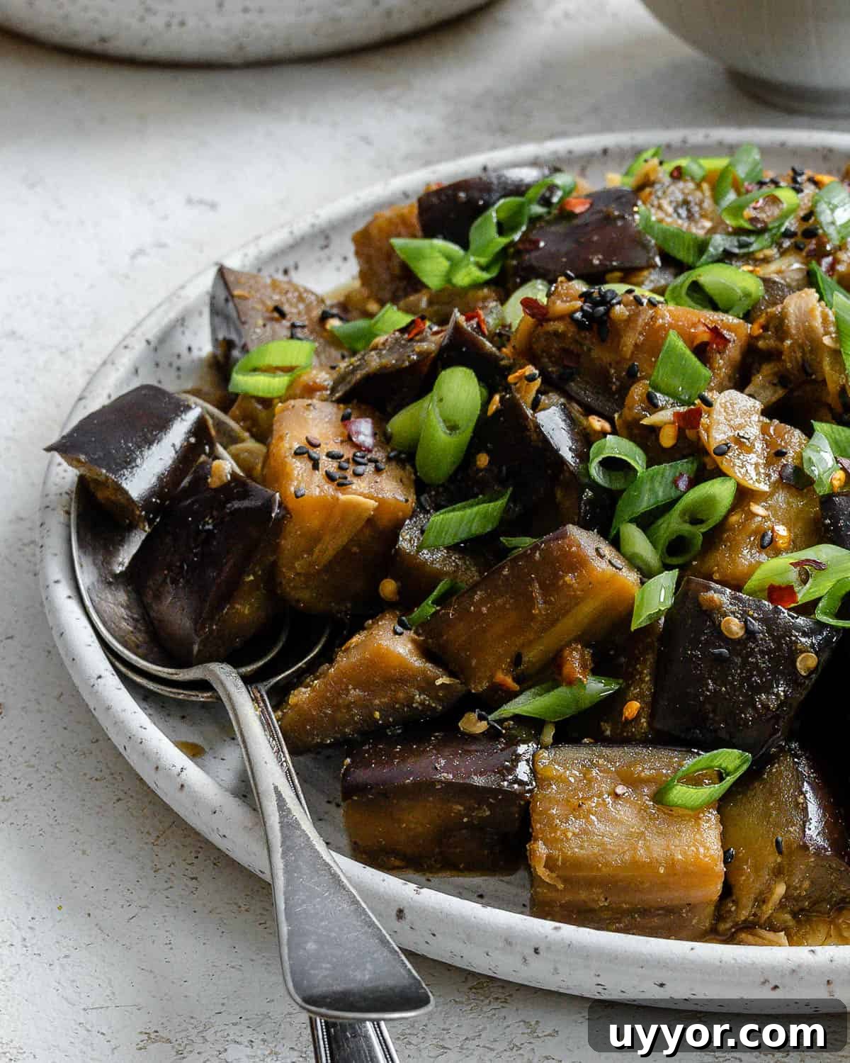 completed Perfect Sautéed Eggplant plated on a plate against a white background