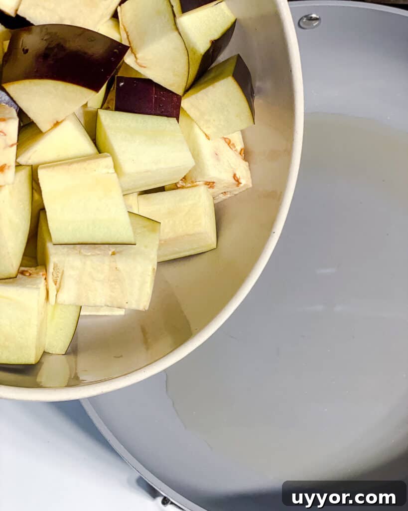 process shot of adding eggplant to pan