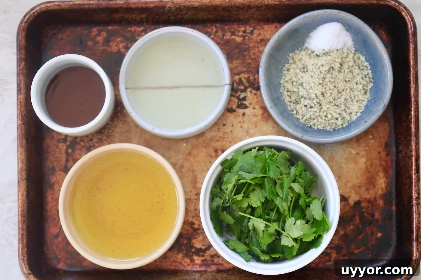 Creamy Cilantro Lime Dressing Recipe for Salads & Marinades 3 cilantro, olive oil, lime juice on baking sheet