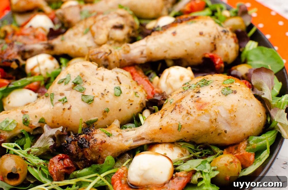 Zesty Italian Chicken Drumsticks served on a plate of salad