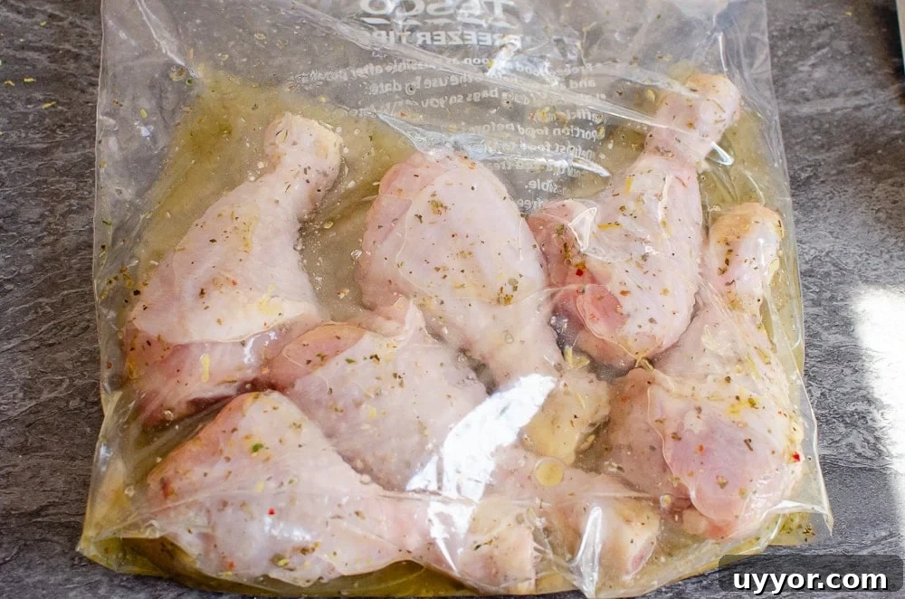 Mixing the Italian marinade and chicken drumsticks together in a clear zip bag