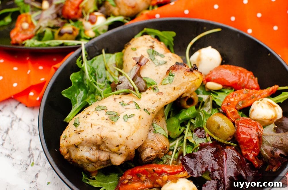 Zesty Italian Chicken Drumsticks served with salad in a black bowl