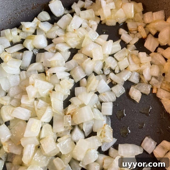 Sautéed onions in a black frying pan