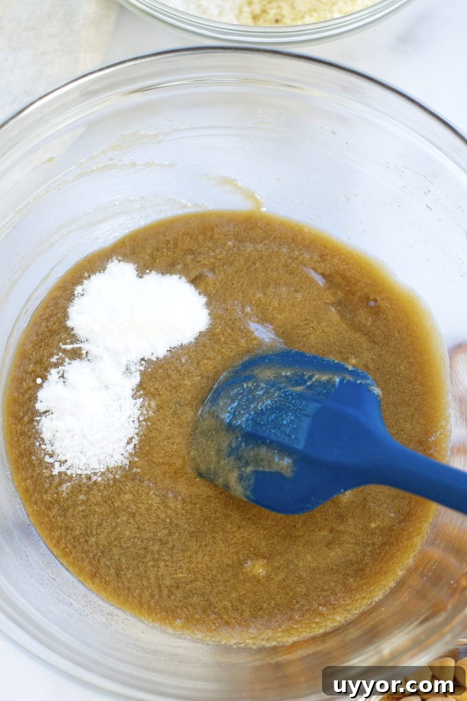Butterscotch Pretzel Cookie Recipe: Sweet & Salty Treat 6 bowl of wet ingredients with baking soda and kosher salt being mixed in