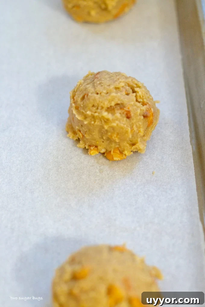Butterscotch Pretzel Cookie Recipe: Sweet & Salty Treat 9 cookie dough scoops on a parchment lined baking sheet