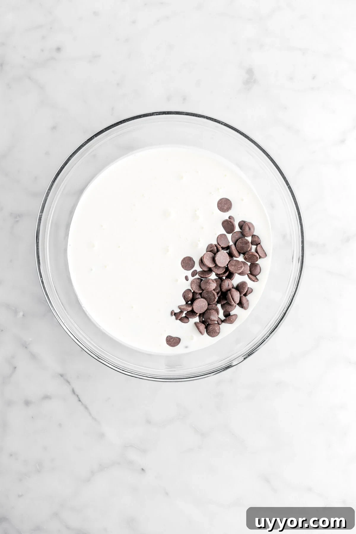 chocolate chips and cream in glass bowl.