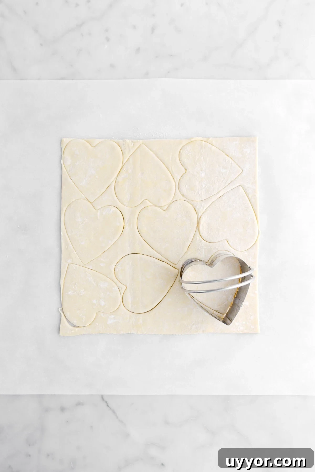 heart shapes cut into sheet of puff pastry.