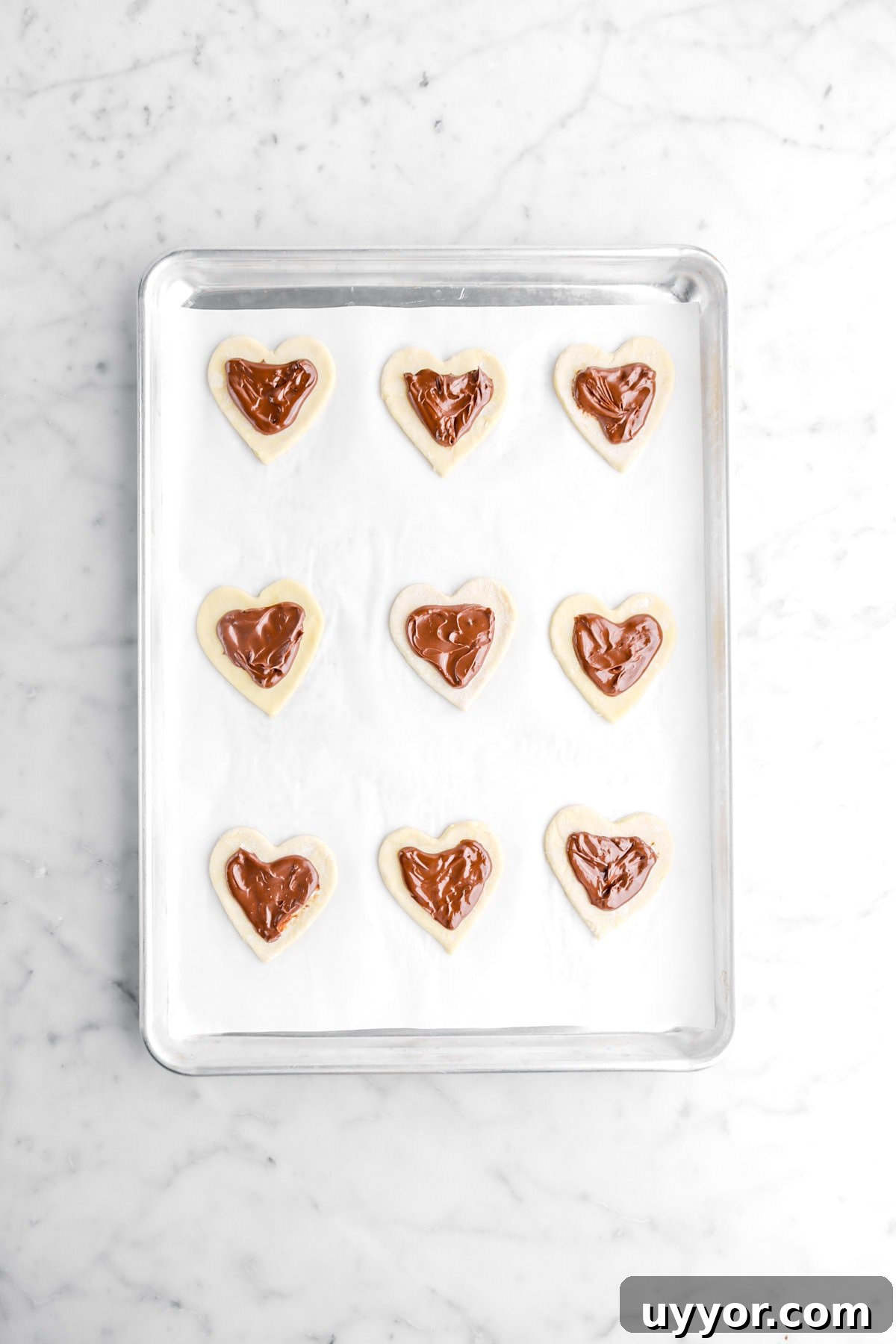chocolate ganache added on top of heart shaped pastry.