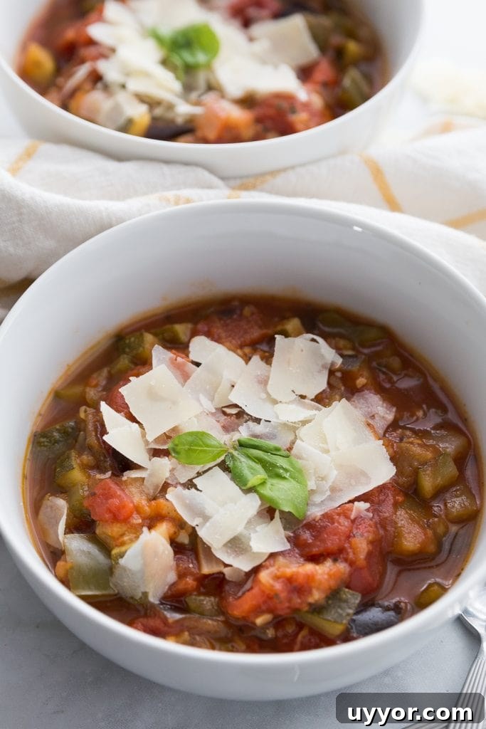 Instant Pot Ratatouille: Quick French Vegetable Stew Recipe 2 Two white bowls full of veggie packed ratatouille topped with Parmesan cheese and basil
