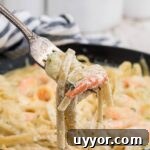 fork digging into shrimp alfredo bake pulling out the noodles
