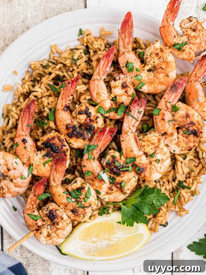 overhead shot of some texas roadhouse grilled shrimp on skewers on top of seasoned rice