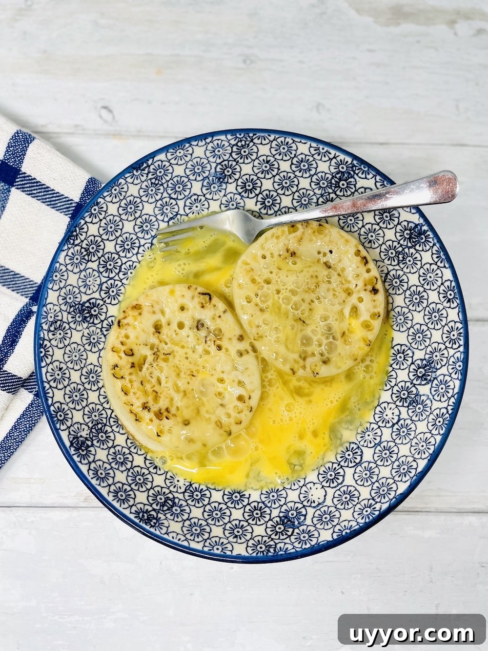 dipping and soaking crumpets in beaten egg mixture