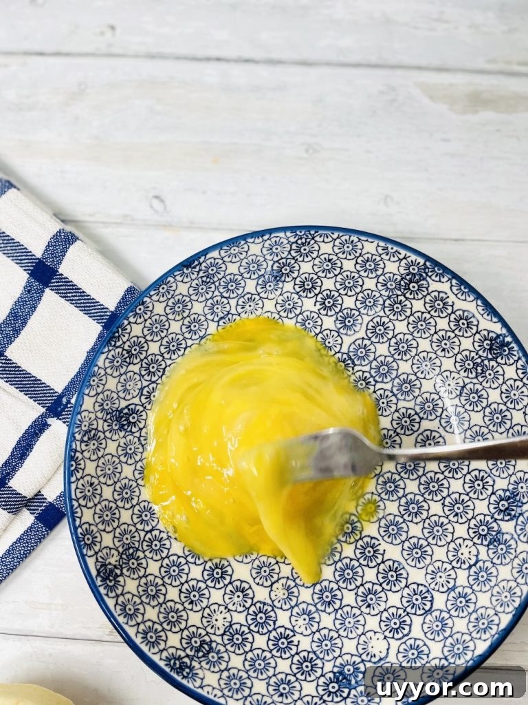 eggs being beaten in a bowl using a fork