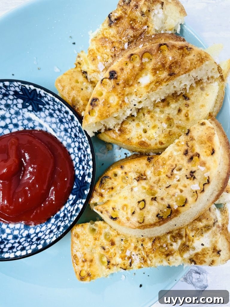 air fryer eggy bread crumpets served with tomato ketchup dip on blue patterned plate