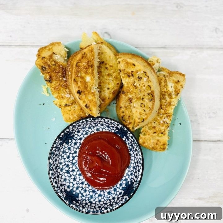 air fryer eggy bread crumpets served with tomato ketchup dip on blue patterned plate