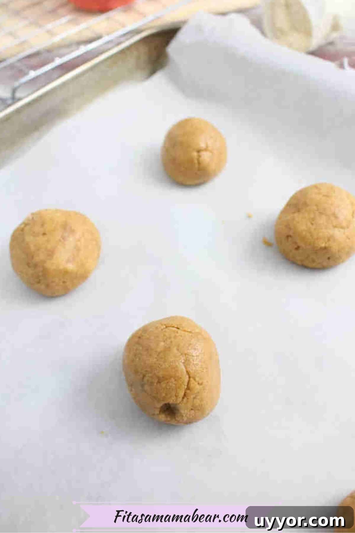 Raw snickerdoodle protein cookies on a parchment paper lined sheet.