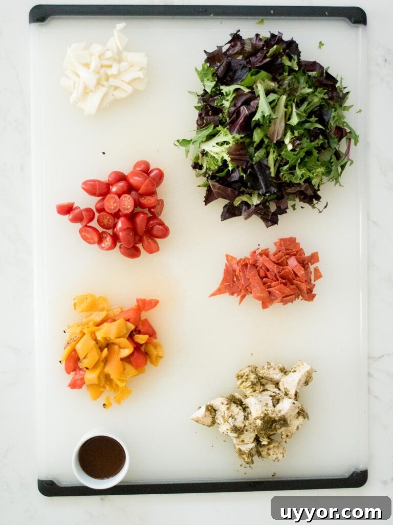 Pesto Chicken Mason Jar Salad Recipe for Meal Prep 3 ingredients on a cutting board for pesto chicken mason jar salad