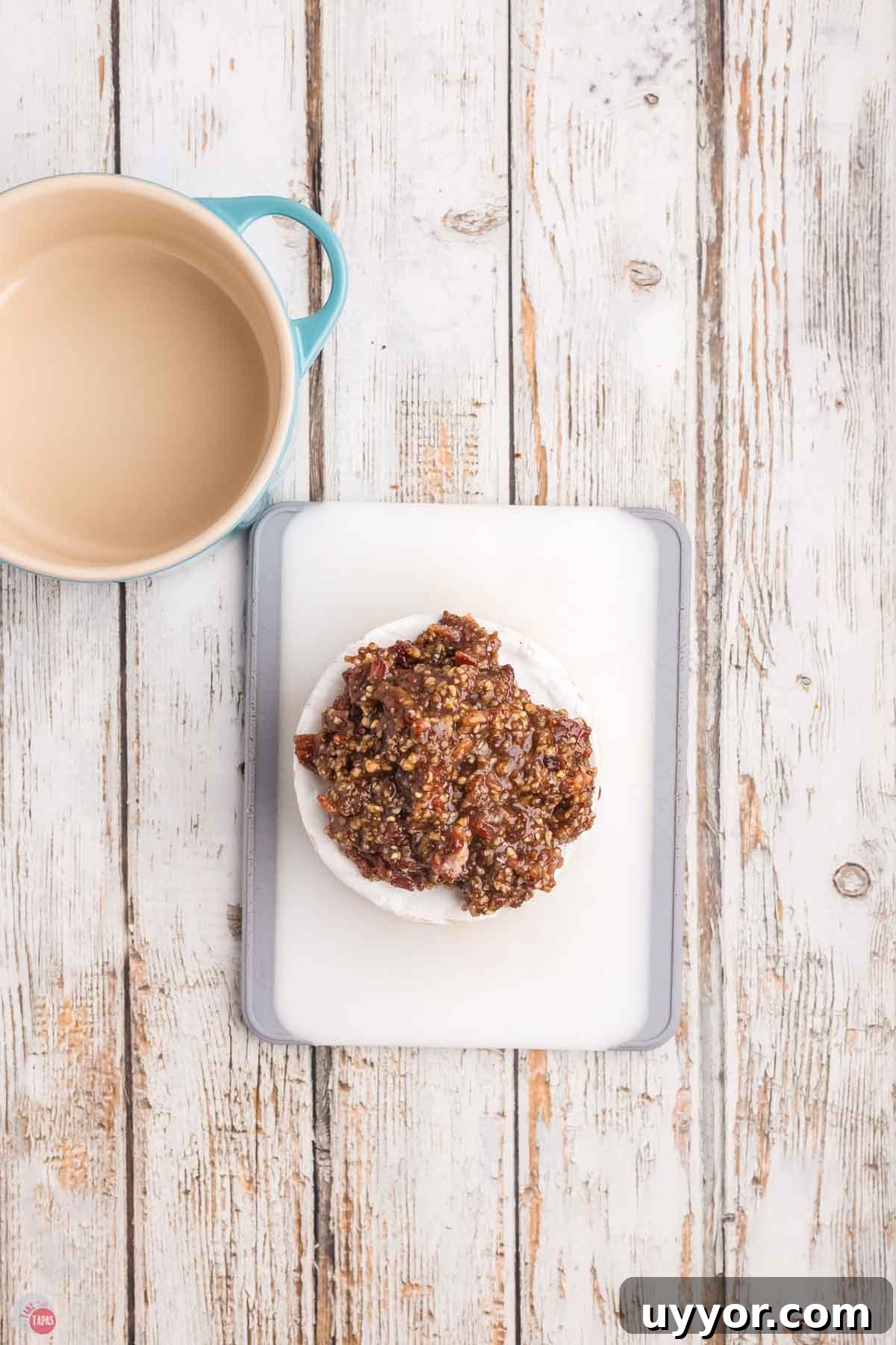 wheel of brie topped with bacon and pecans