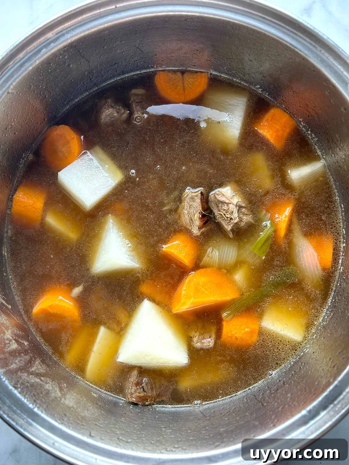 Hearty Beef Brisket Noodle Soup Recipe for Comforting Dinner 7 daikon and carrots added to pot