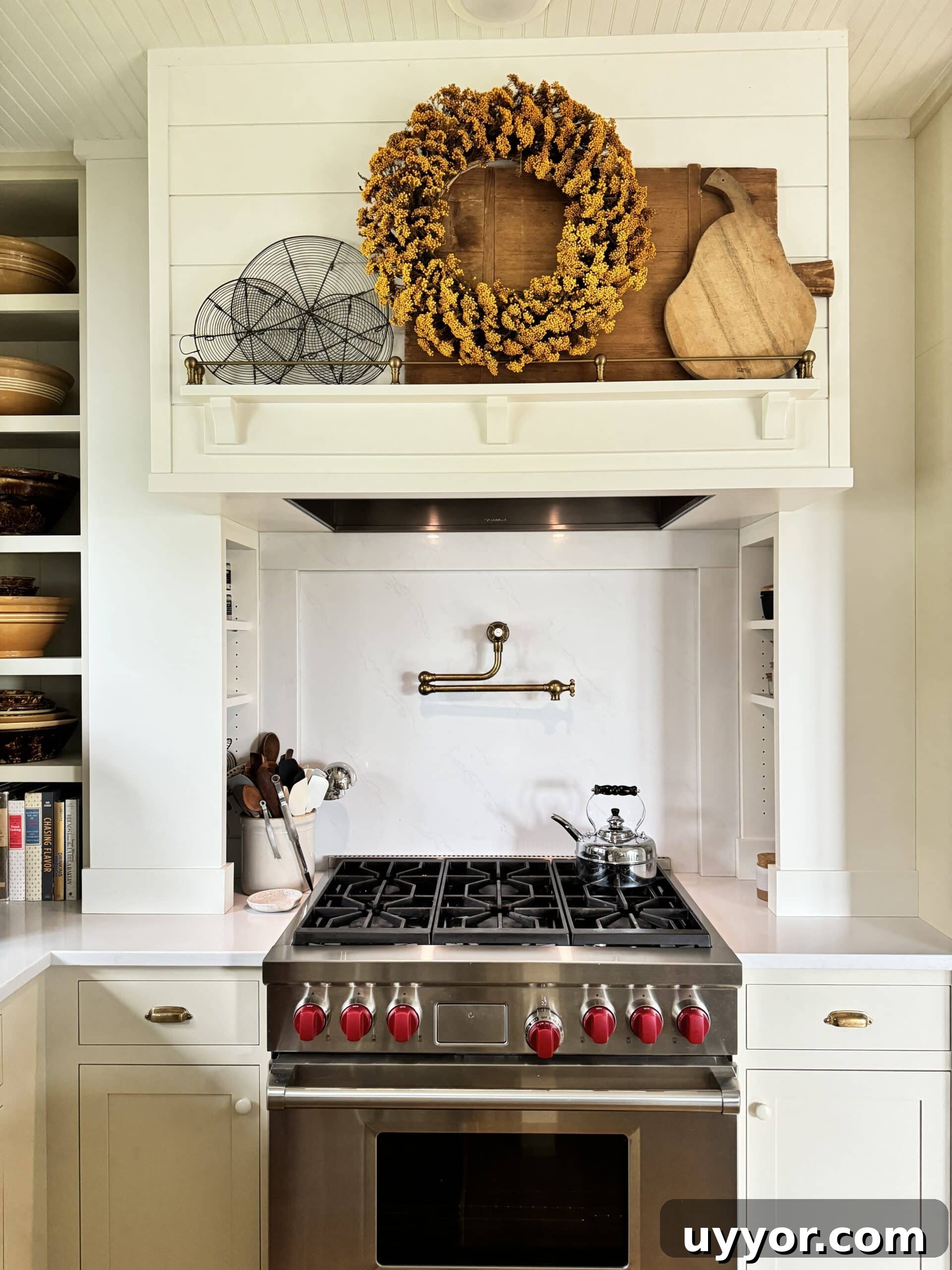 August 2024 Events, Deals & Planning Guide 5 Hood above range in kitchen with yellow fall-themed wreath hanging.