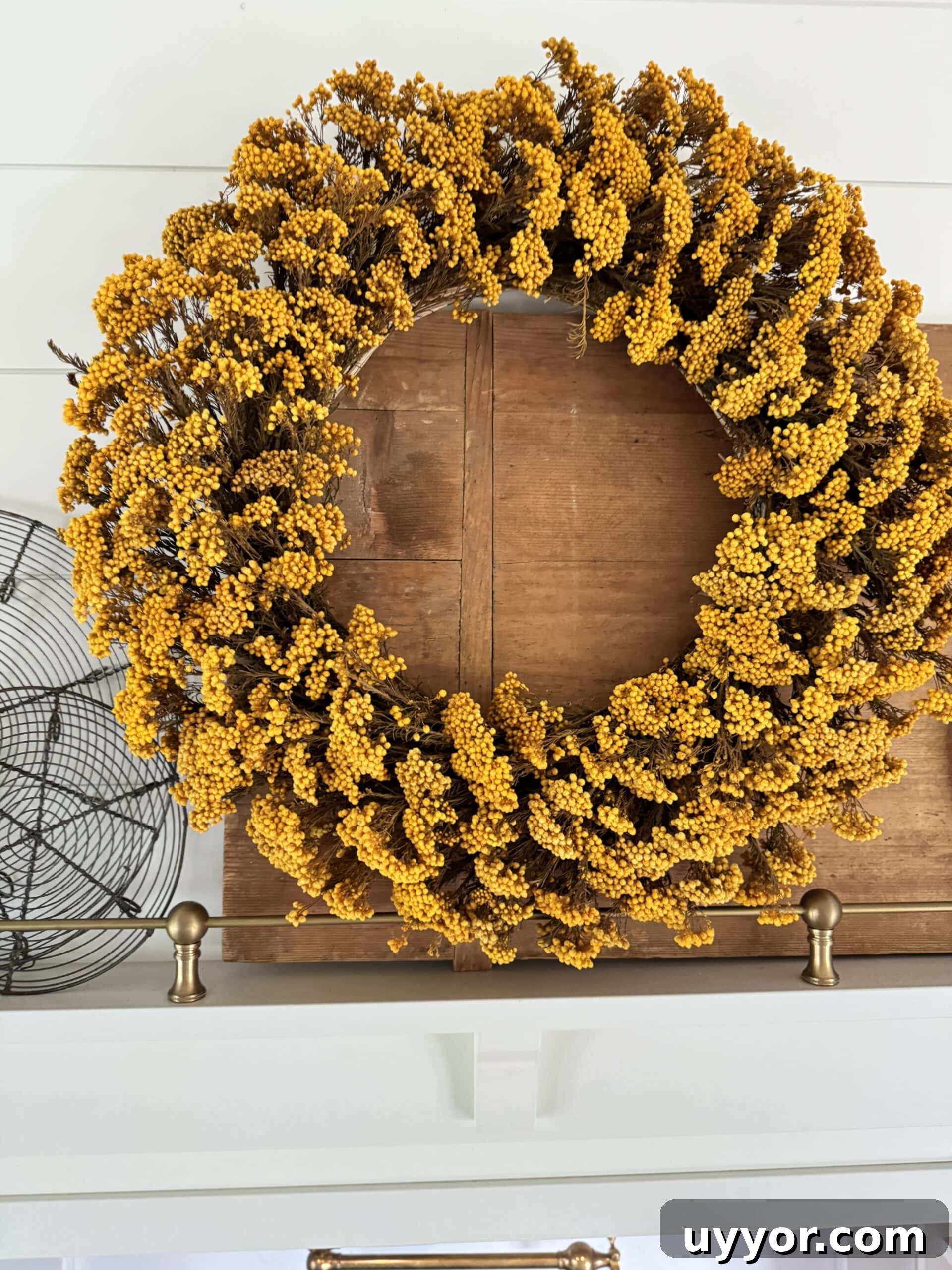 August 2024 Events, Deals & Planning Guide 6 Yellow wreath hanging on a hood with cutting board and wire cooling rack behind.