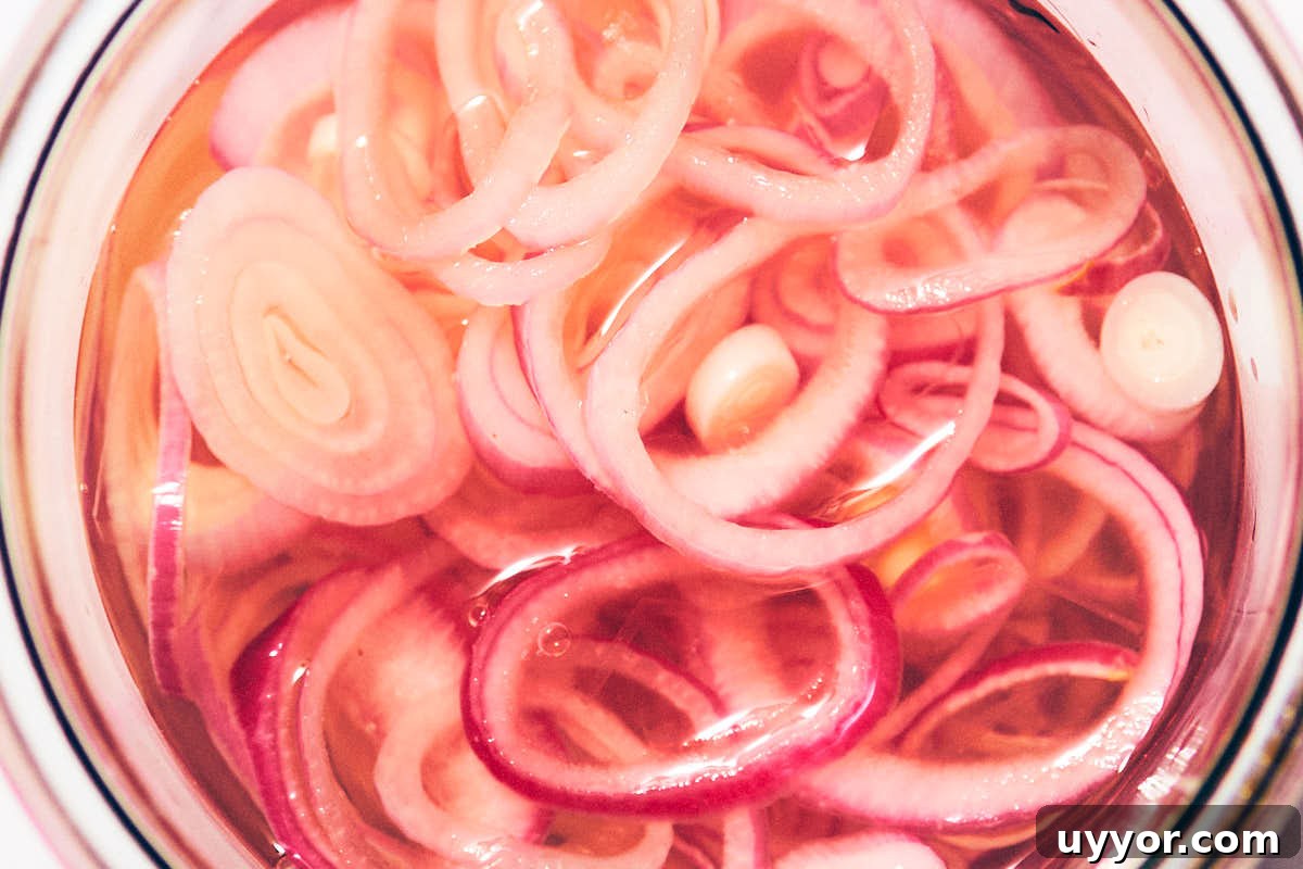 Quick pickled shallots in a jar, ready to eat.