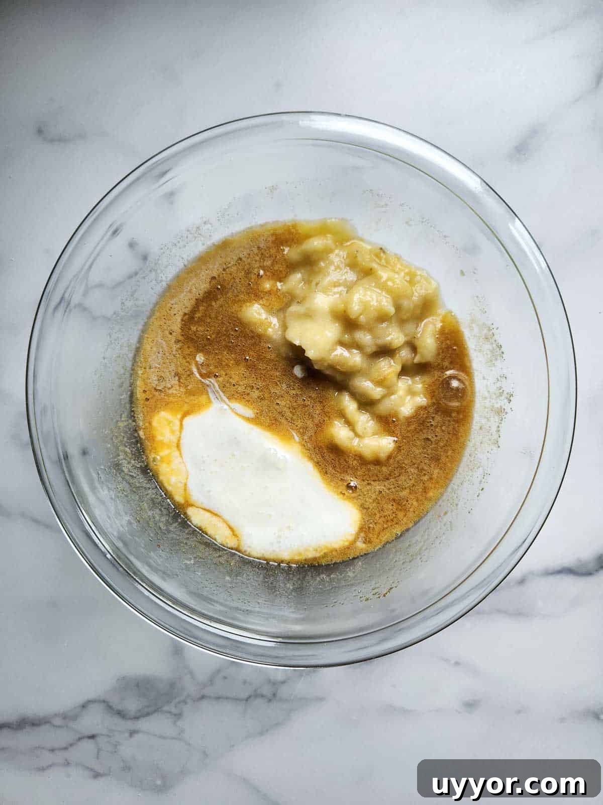 Bakery-Style Banana Bread with Pecans and Brown Butter Glaze 6 Wet ingredients for banana bread in a bowl.