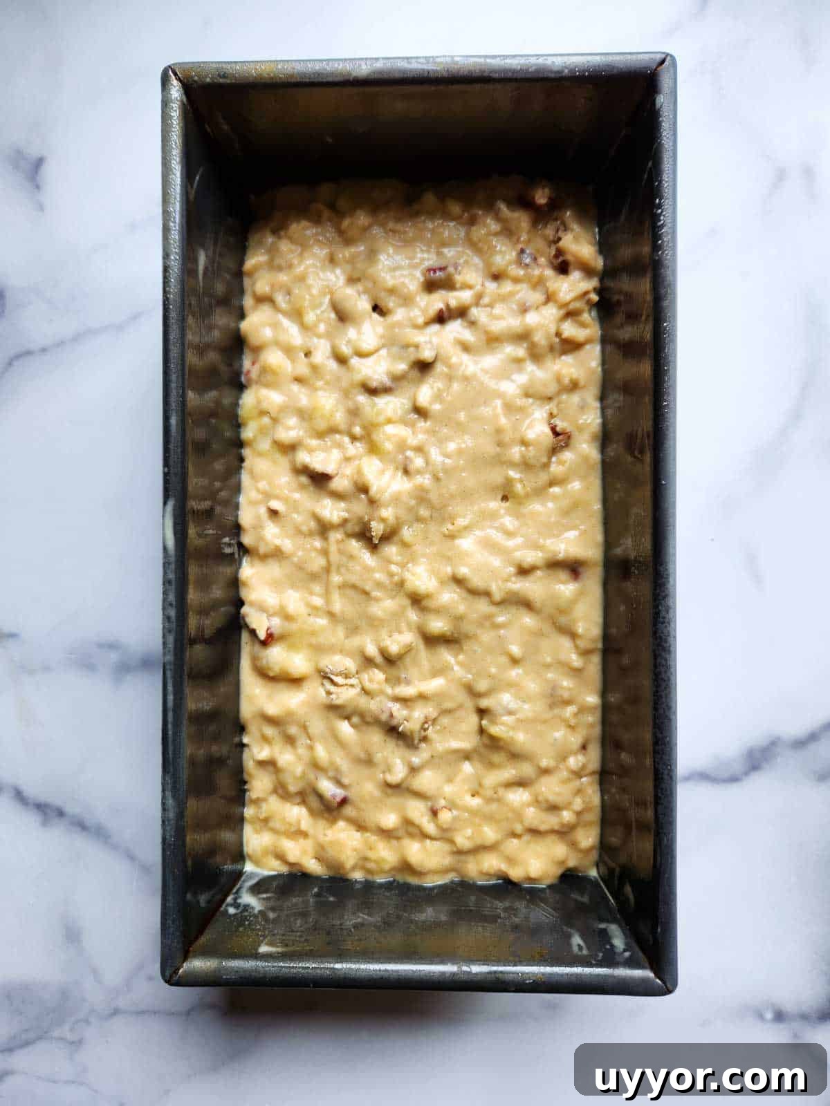 Bakery-Style Banana Bread with Pecans and Brown Butter Glaze 9 Banana bread batter in a loaf pan.