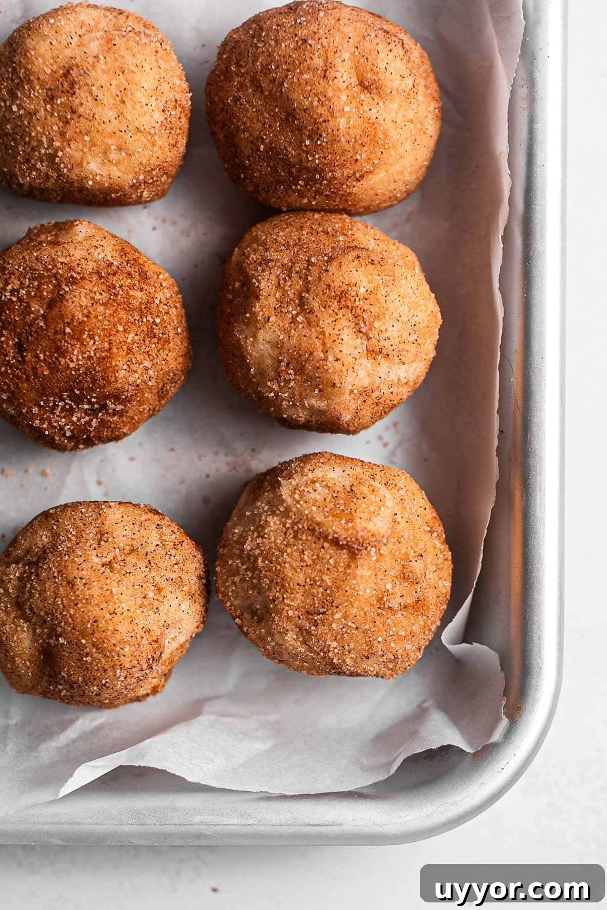 Freeze Cookie Dough and Bake from Frozen: Step-by-Step Guide 2 Eggless snickerdoodle cookie dough balls on a parchment-lined baking sheet.