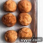 Cookie dough balls on a silver baking tray.