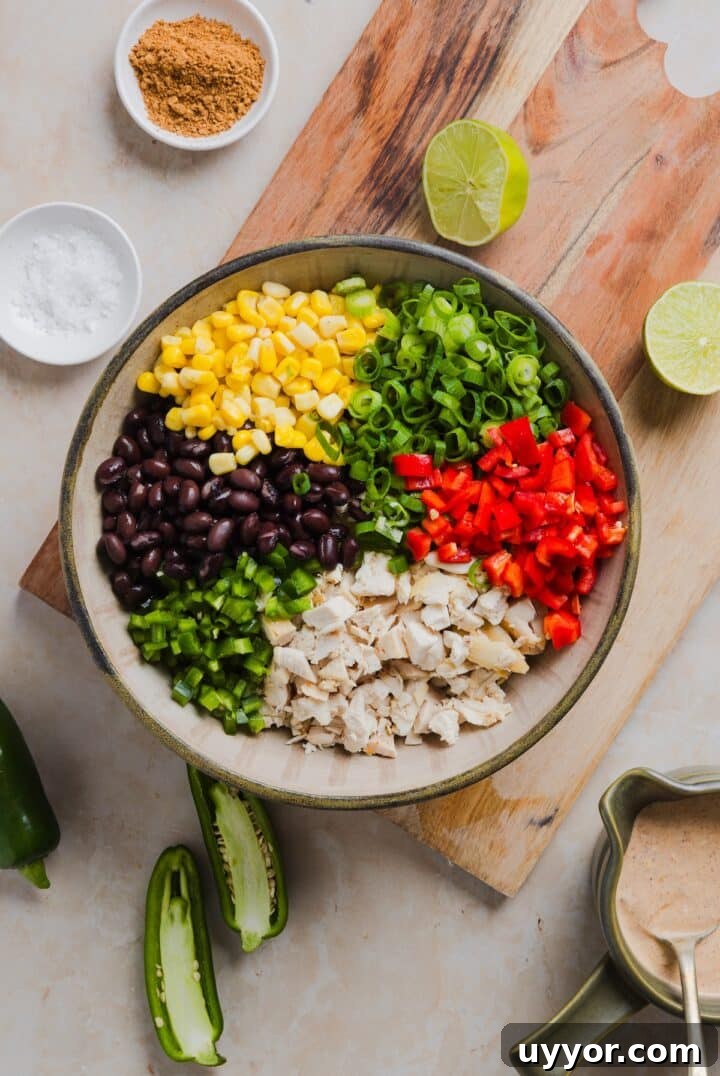Ingredients for southwest chicken salad in a large mixing bowl.
