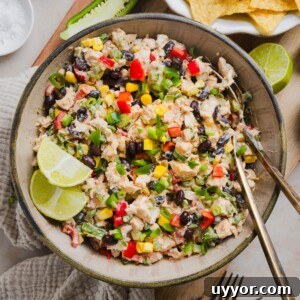 Southwest chicken salad in a serving bowl with lime wedges.