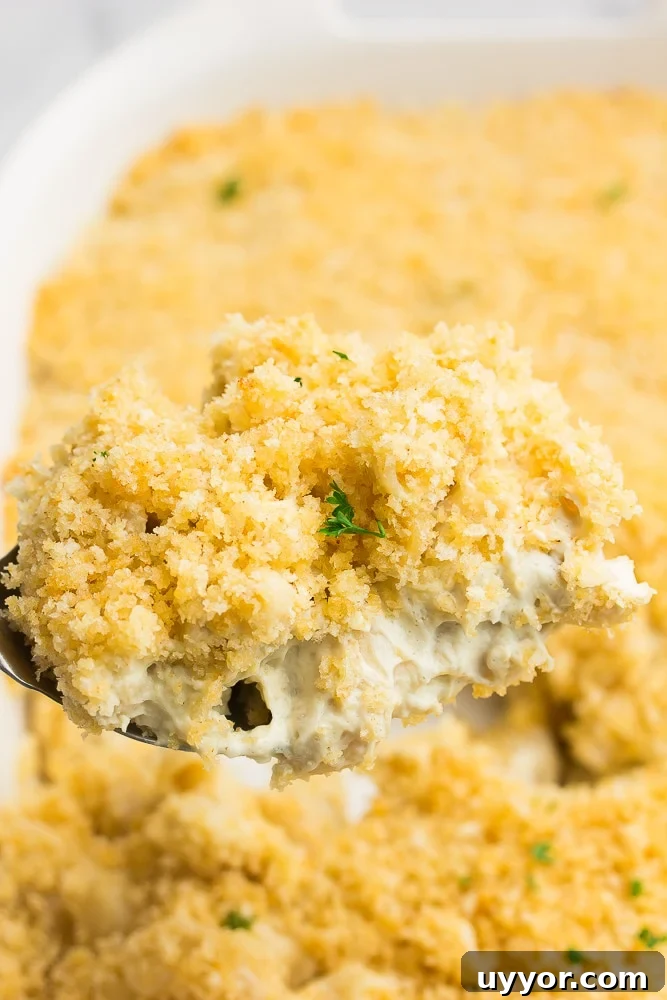 Creamy Vegan Baked Macaroni and Cheese Casserole 3 spoon taking a serving out of vegan baked mac and cheese