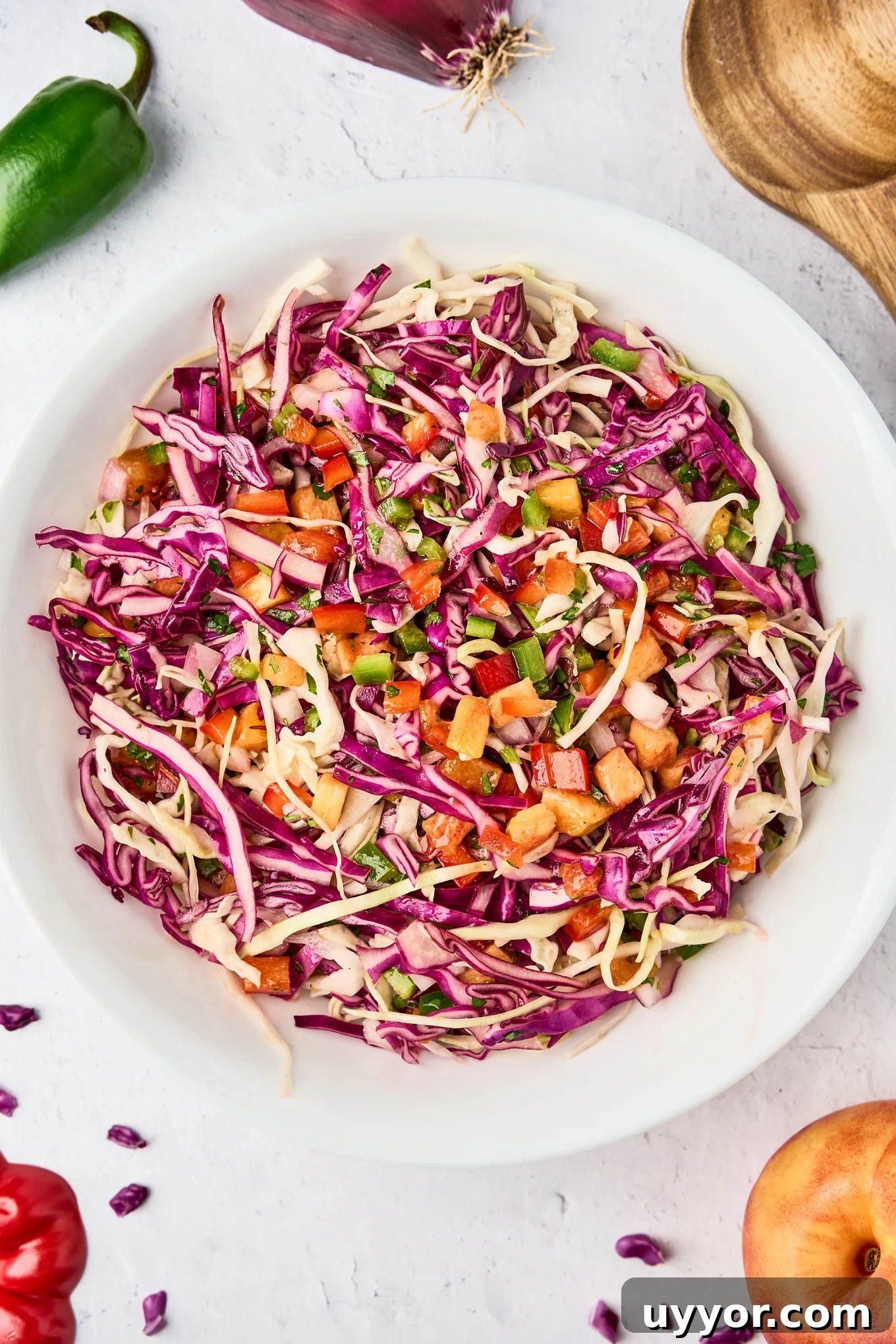 Spicy Shrimp Tacos with Caramelized Sweet Plantains 6 Bowl of tropical slaw with green and red cabbage, nectarine, red bell pepper, jalapeño, red onion, and cilantro tossed in a citrus dressing.