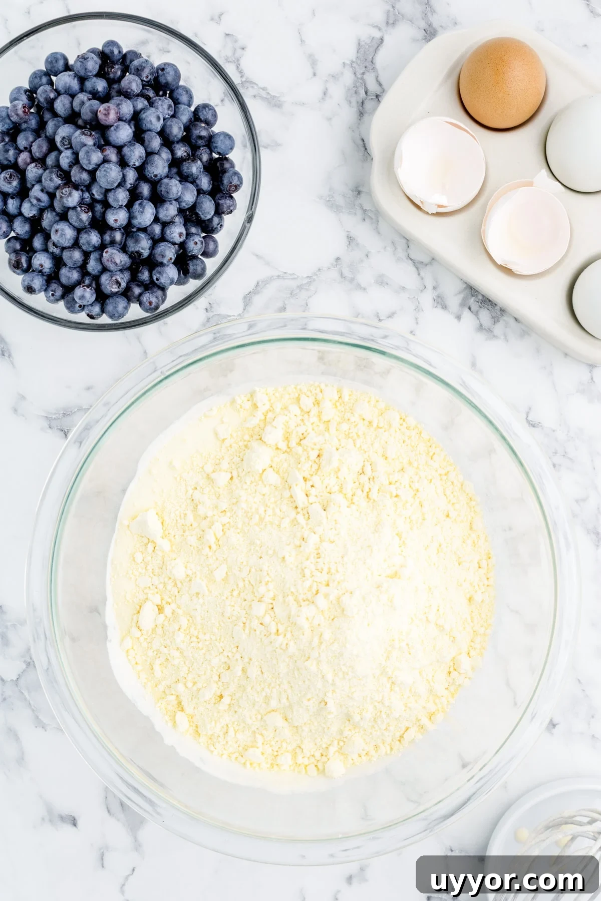 Blueberry Muffins from Cake Mix: Quick Homemade Recipe 5 Combining the wet ingredients with lemon cake mix in a bowl until no dry spots remain