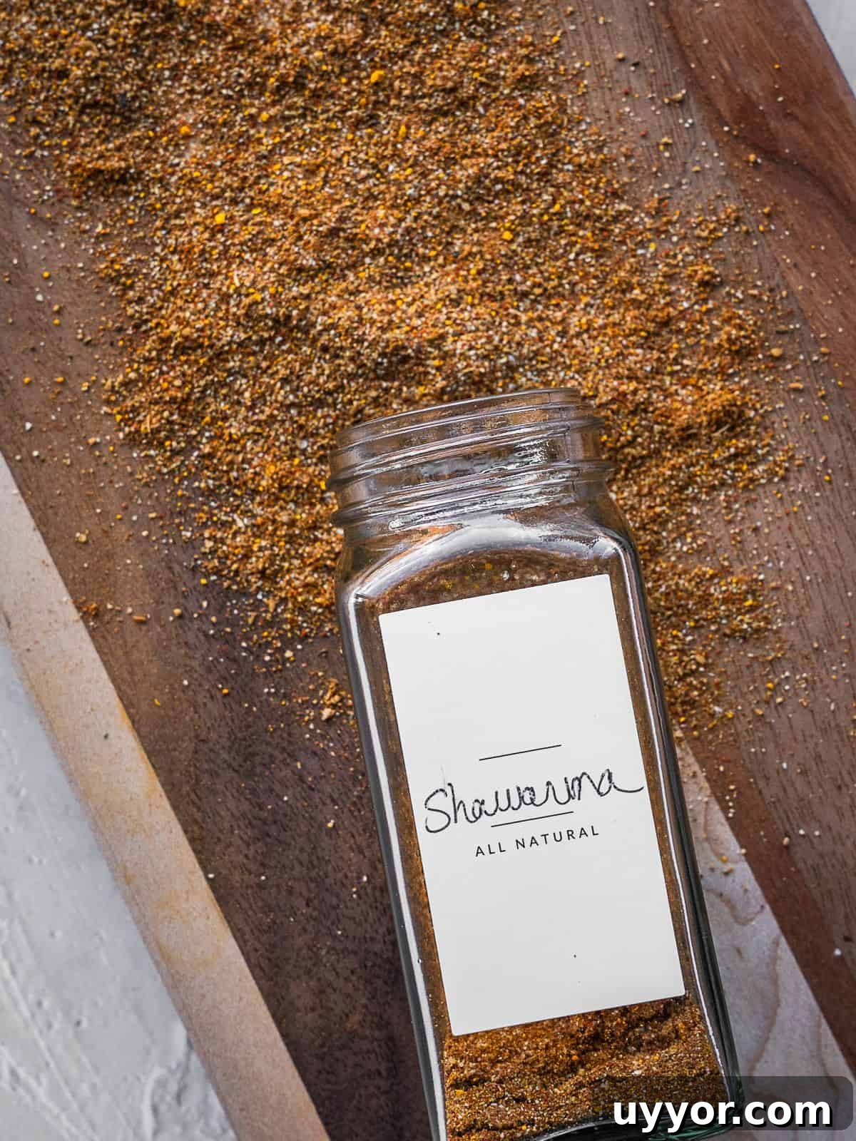 Shawarma spice mix jar on a cutting board.