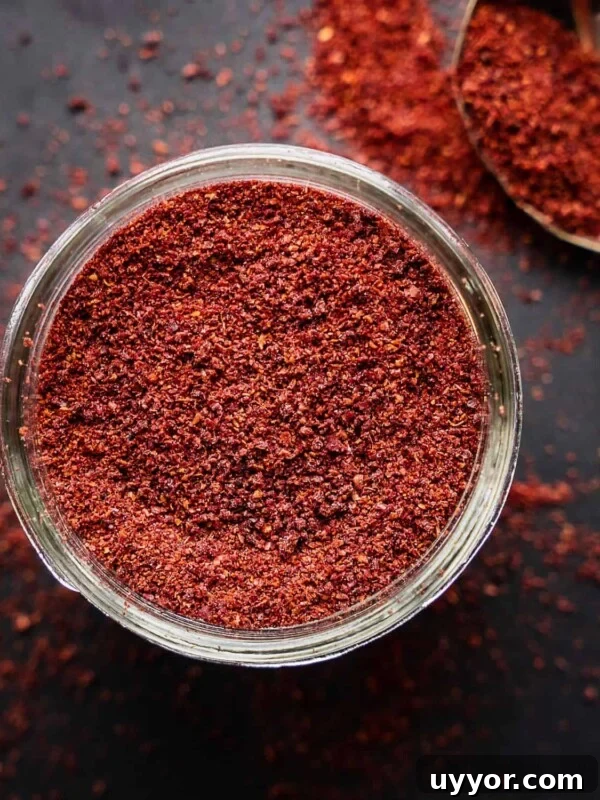 Sumac spice in an open mason jar.