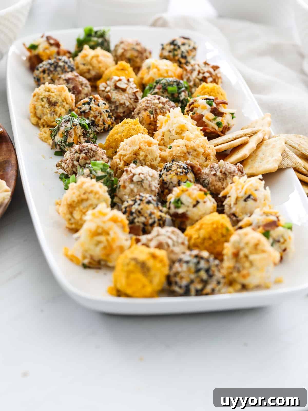 Savory Mini Cheese Truffles: Bite-Sized Party Cheese Balls 11 Side view of platter filled with mini cheese truffles